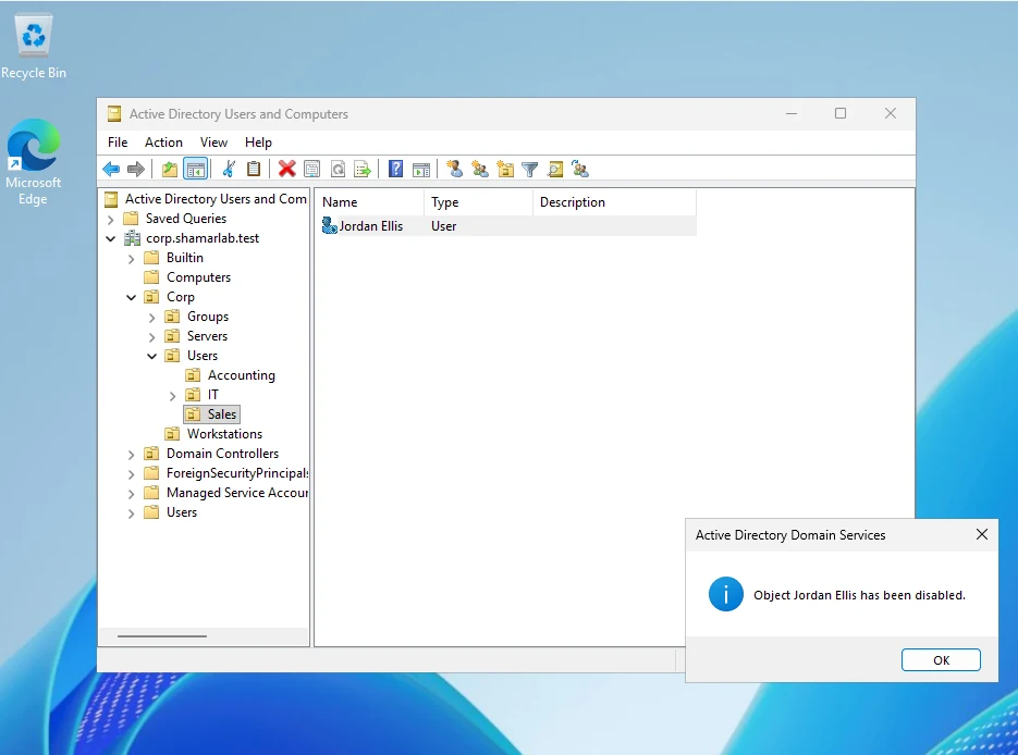 Active Directory Users and Computers on the Sales OU with a message confirming Jordan Ellis has been disabled