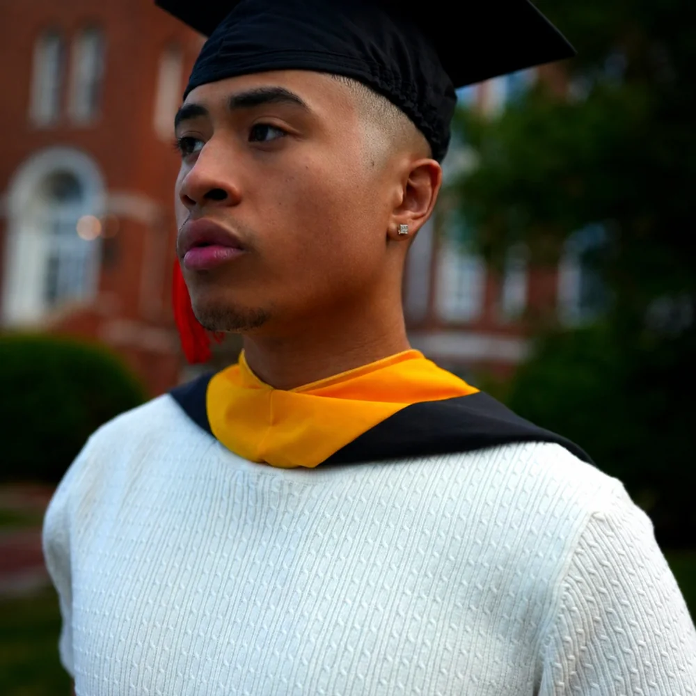 Portrait of Shamar Bryant in a graduation cap and hood